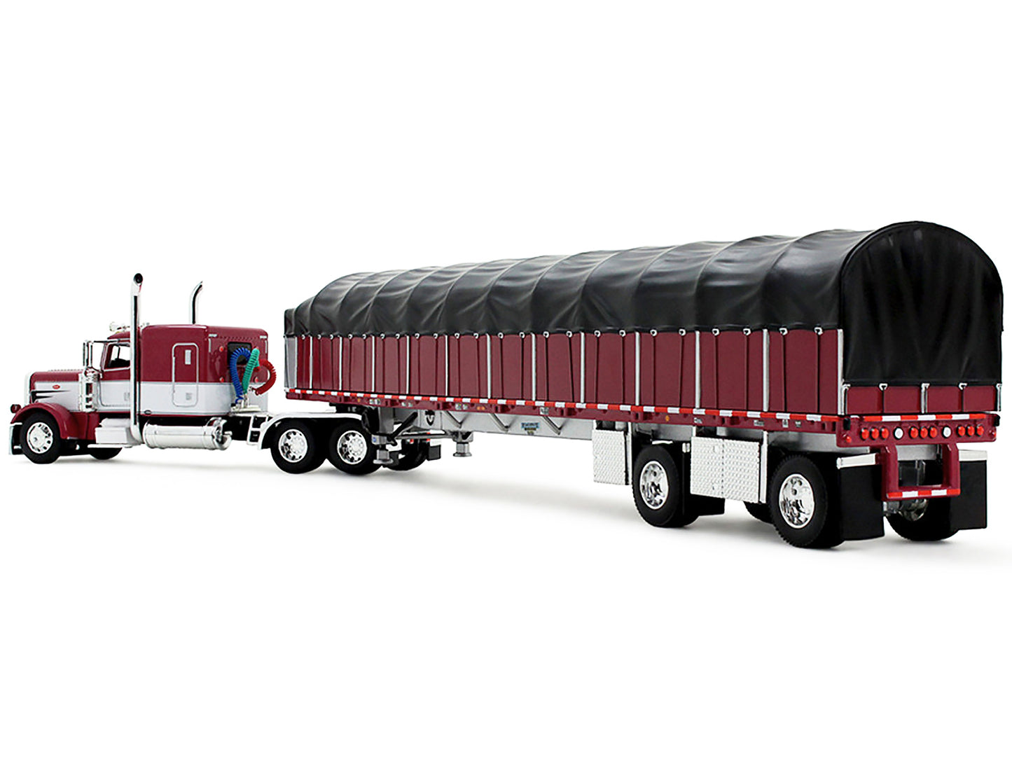 Peterbilt 389 with 63" Flat Top Sleeper and 53’ Wilson Roadbrute Flatbed Trailer with Covered Wagon Maroon with White Stripes 1/64 Diecast Model by DCP/First Gear-DiecastModeler.com
