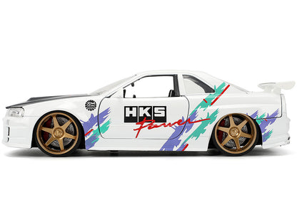 2002 Nissan Skyline GT-R (R34) RHD (Right Hand Drive) "HKS Power" White with Carbon Hood and Graphics "JDM Tuners" Series 1/24 Diecast Model Car by Jada-DiecastModeler.com