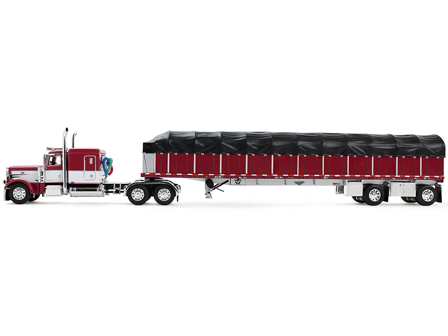 Peterbilt 389 with 63" Flat Top Sleeper and 53’ Wilson Roadbrute Flatbed Trailer with Covered Wagon Maroon with White Stripes 1/64 Diecast Model by DCP/First Gear-DiecastModeler.com