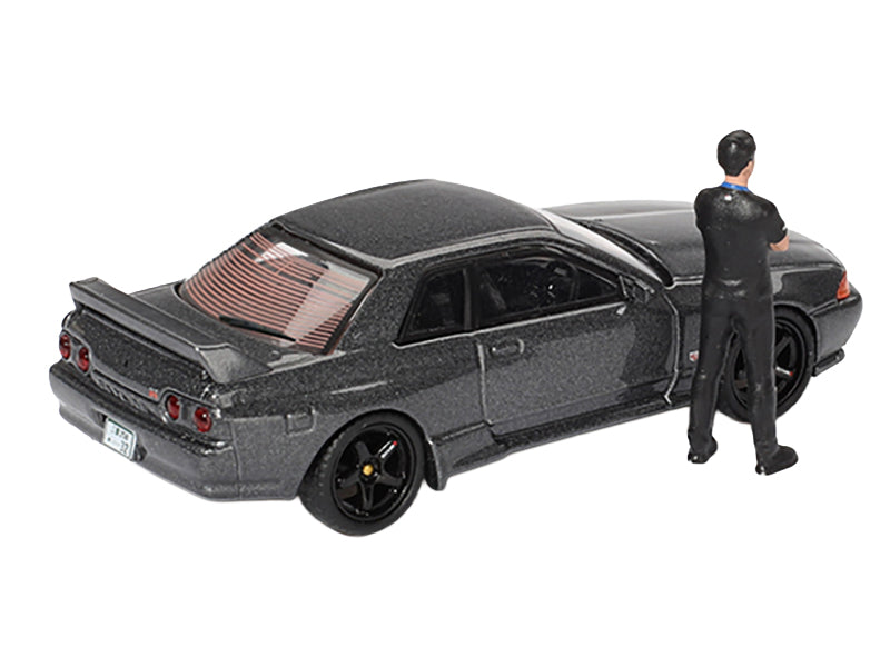 Nissan Skyline GT-R (R32) RHD (Right Hand Drive) Gunmetal Gray Metallic with Tsugio Matsuda Figure Limited Edition 1/64 Diecast Model Car by Mini GT-DiecastModeler.com