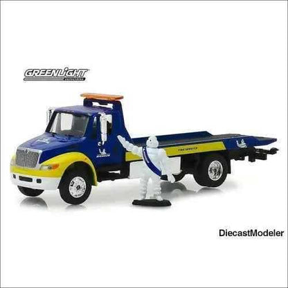 Greenlight - 2013 International Durastar Flatbed Truck with Michelin Man Figure 1:64-DiecastModeler.com