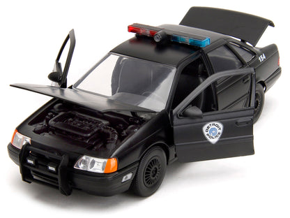 Ford Taurus OCP Matt Black "Detroit Police" and Robocop Diecast Figure 35th Anniversary "Robocop" (1987) Movie "Hollywood Rides" Series 1/24 Diecast Model Car by Jada-DiecastModeler.com