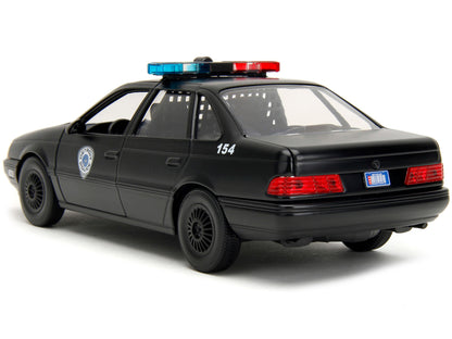 Ford Taurus OCP Matt Black "Detroit Police" and Robocop Diecast Figure 35th Anniversary "Robocop" (1987) Movie "Hollywood Rides" Series 1/24 Diecast Model Car by Jada-DiecastModeler.com
